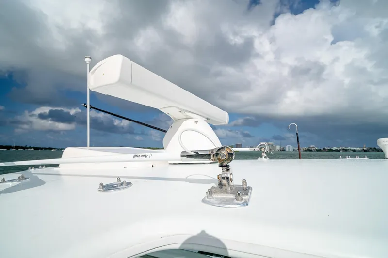 Slide: The Image of Rooftop view of 2023 SeaVee 390Z boat with radar equipment under cloudy sky. - 39