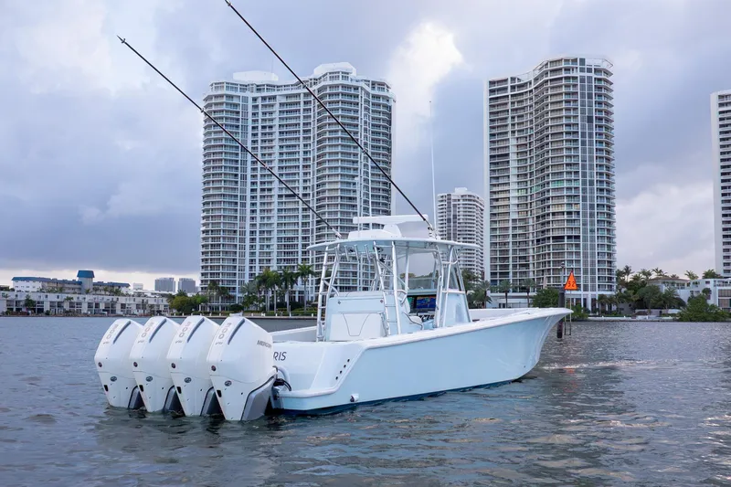 Slide: The Image of 2023 SeaVee 390Z boat with four engines, docked near high-rise buildings. - 4