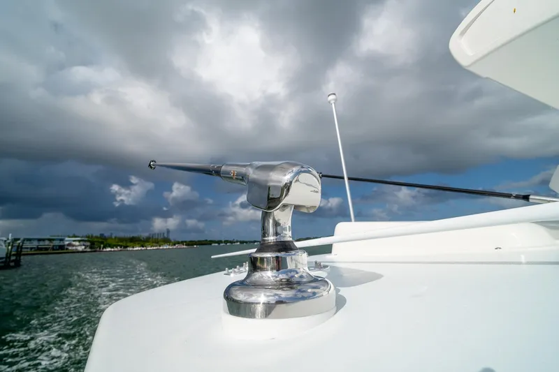 Slide: The Image of Close-up of 2023 SeaVee 390Z boat's chrome fixture against cloudy sky. - 40
