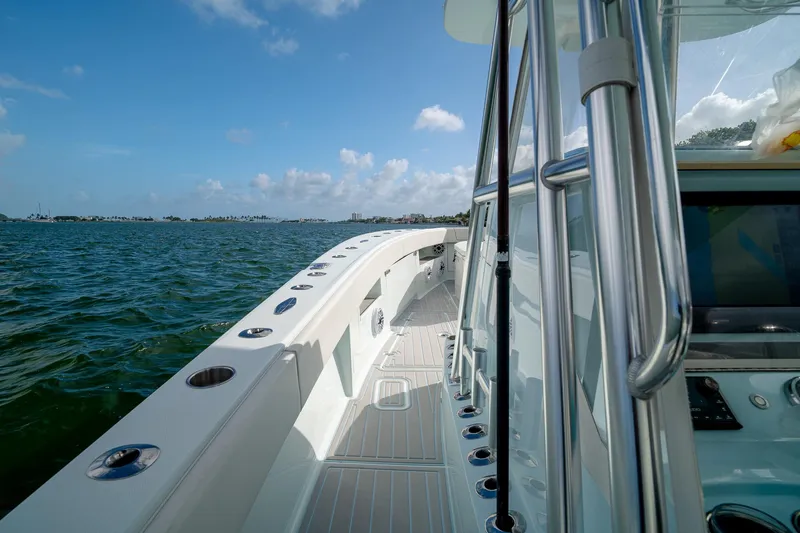 Slide: The Image of 2023 SeaVee 390Z boat on water, showcasing sleek design and spacious deck. - 46
