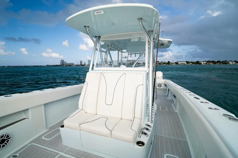 Slide: The Image of 2023 SeaVee 390Z boat with white seating, cruising on open water. - 54