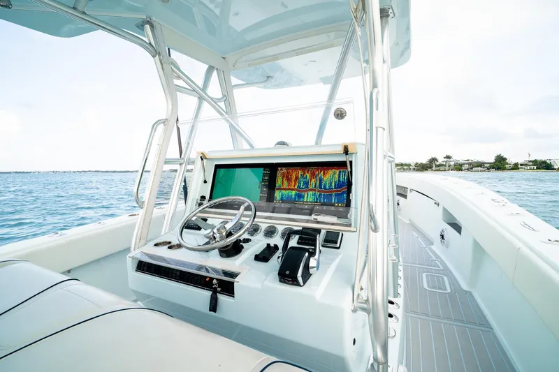 Slide: The Image of 2023 SeaVee 390Z boat helm with advanced navigation system on open water. - 55