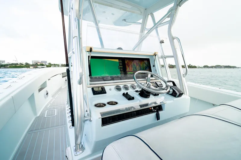 Slide: The Image of 2023 SeaVee 390Z boat cockpit with advanced navigation system and steering wheel. - 56