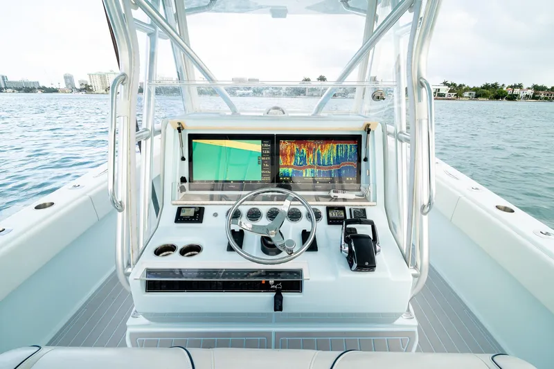 Slide: The Image of 2023 SeaVee 390Z boat dashboard with advanced navigation and control systems on open water. - 57