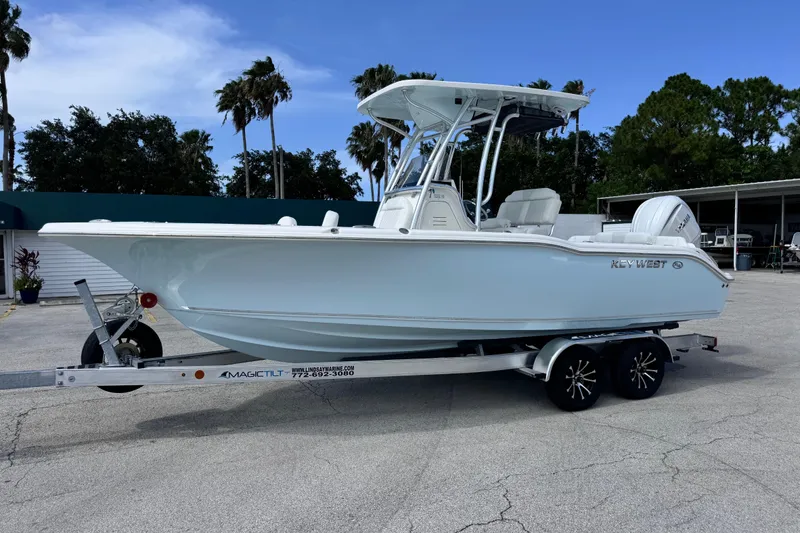 The Image of 2026 Key West 239 FS boat on trailer, parked outdoors under clear sky. - 0