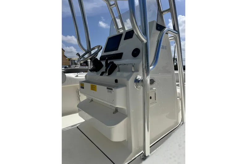 Slide: The Image of 2026 Key West 239 FS boat console with steering wheel and controls under a clear sky. - 10