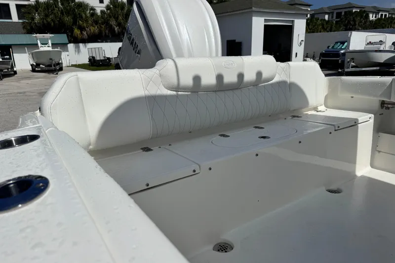 Slide: The Image of 2026 Key West 239 FS boat interior with white seating and storage compartments. - 12