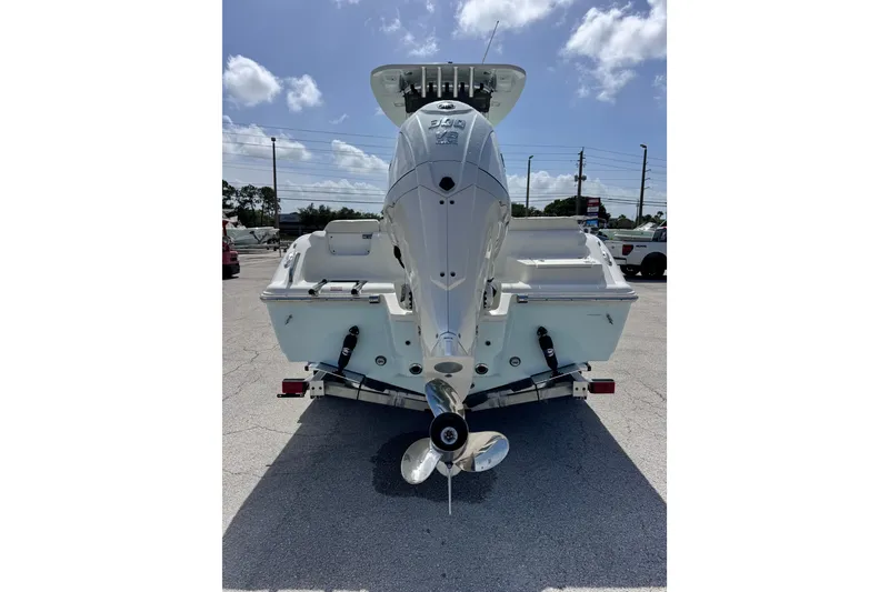 Slide: The Image of 2026 Key West 239 FS boat rear view with outboard motor in parking lot. - 3
