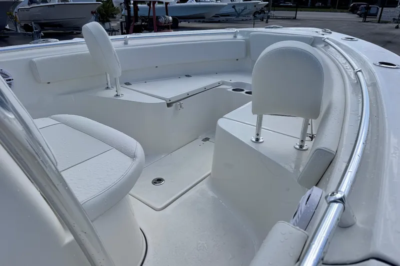 Slide: The Image of 2026 Key West 239 FS boat interior with white seating and sleek design. - 7