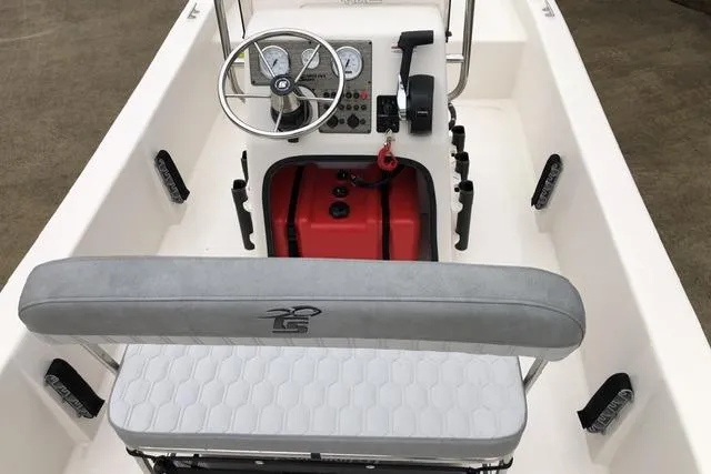 Slide: The Image of 2025 Carolina Skiff E18 JVX CC boat interior with steering wheel and seating. - 2