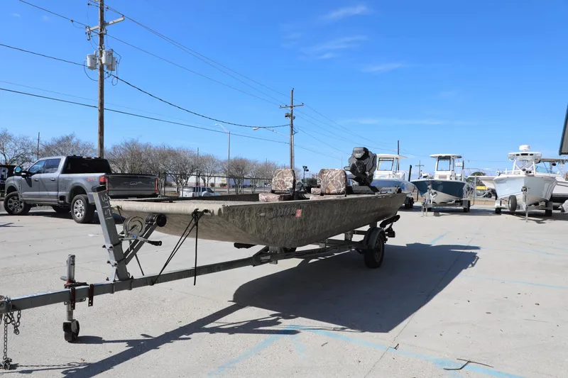 Slide: The Image of 2017 Gator Tail 16 boat on trailer in parking lot under clear blue sky. - 10