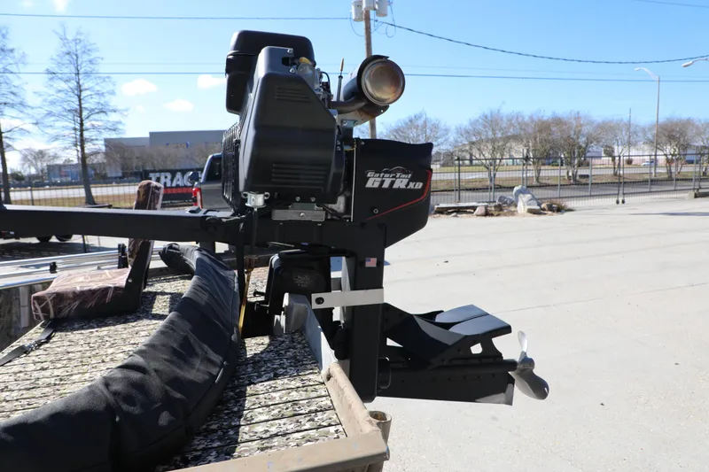 Slide: The Image of 2017 Gator Tail 16 outboard motor on a boat trailer in a parking lot. - 3