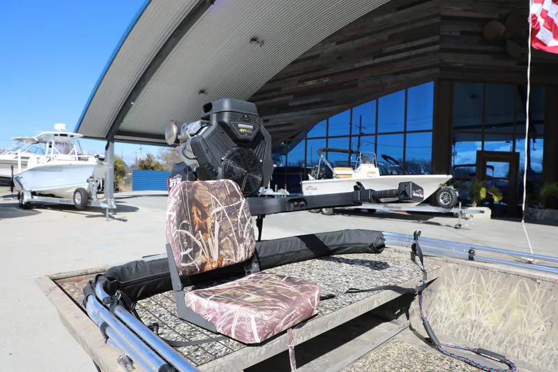 Slide: The Image of 2017 Gator Tail 16 boat with camouflage seat and motor, displayed outdoors. - 4