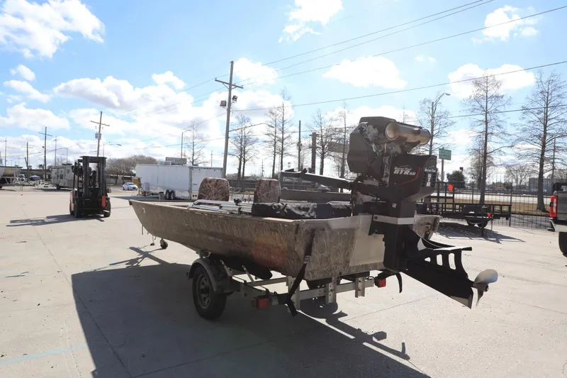 Slide: The Image of 2017 Gator Tail 16 boat on trailer in outdoor lot under blue sky. - 8