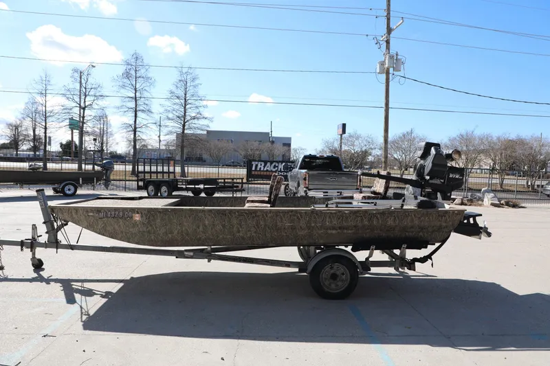 Slide: The Image of 2017 Gator Tail 16 boat on trailer in parking lot, clear sky background. - 9
