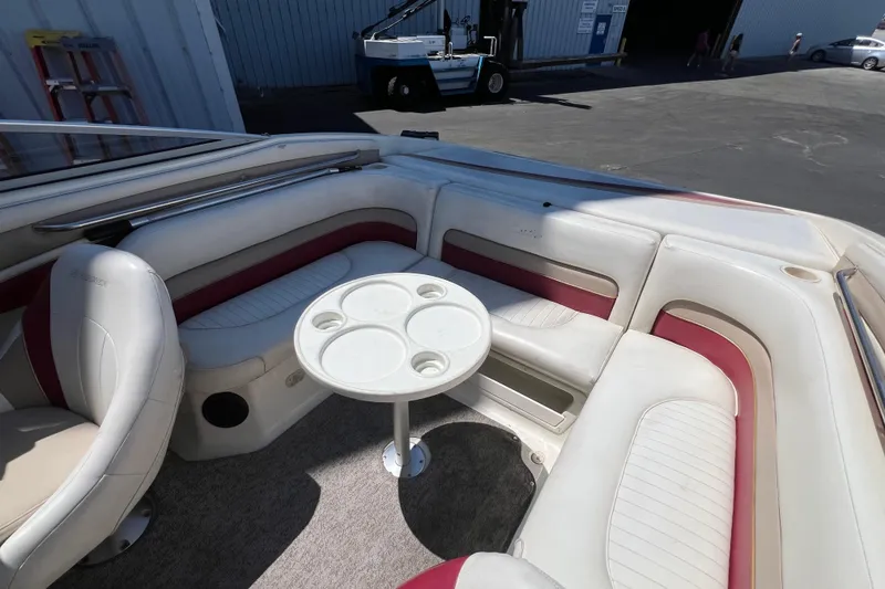 Slide: The Image of Interior of a 1996 Rinker 232 Captiva Cuddy boat with seating and table. - 4