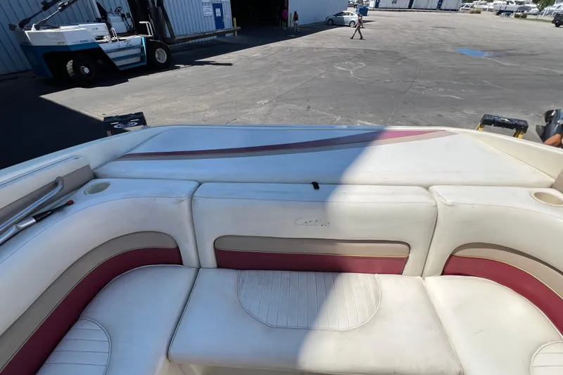 Slide: The Image of 1996 Rinker 232 Captiva Cuddy boat interior with white and maroon seating. - 6