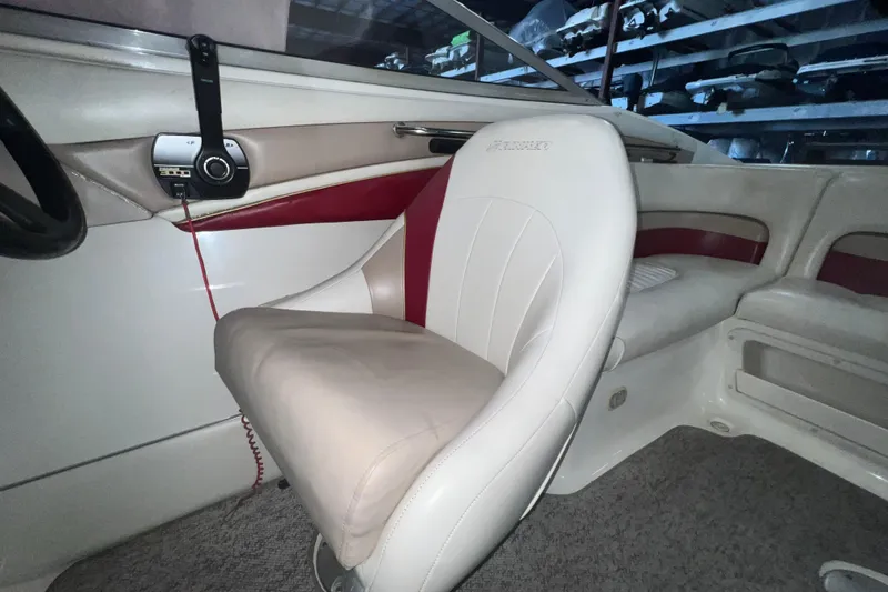 Slide: The Image of Interior of a 1996 Rinker 232 Captiva Cuddy boat, featuring a white captain's chair. - 7