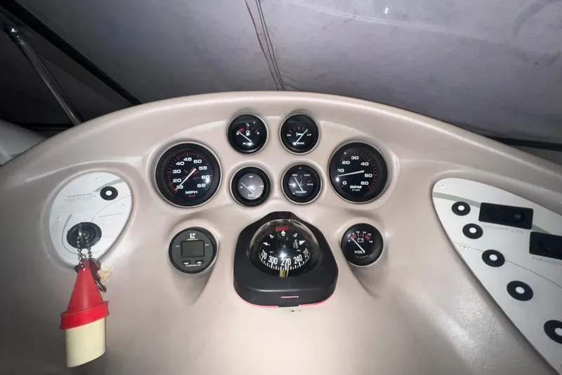Slide: The Image of Dashboard of a 1996 Rinker 232 Captiva Cuddy boat with gauges and compass. - 9
