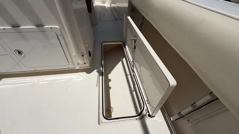 Slide: The Image of Storage compartment on a 2015 Cobia 296 Center Console boat. - 10