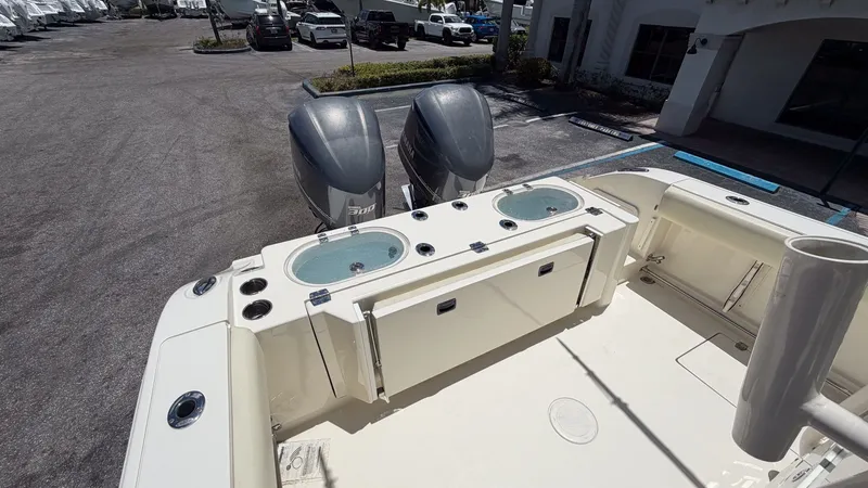 Slide: The Image of 2015 Cobia 296 Center Console with dual outboard engines. - 13