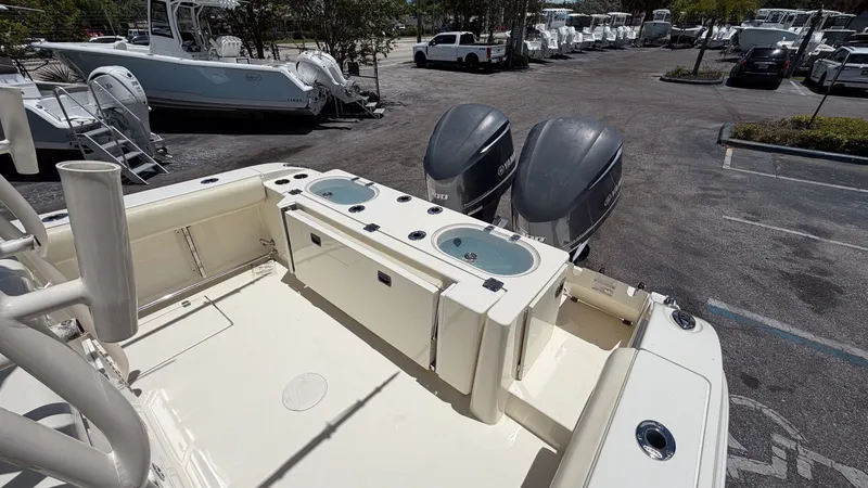 Slide: The Image of 2015 Cobia 296 Center Console with dual engines at dock. - 14