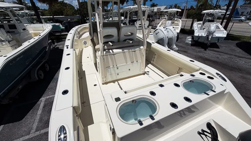 Slide: The Image of 2015 Cobia 296 Center Console boat with spacious deck and dual engines. - 15