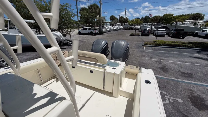 Slide: The Image of 2015 Cobia 296 Center Console boat in parking lot with outboard motors. - 3