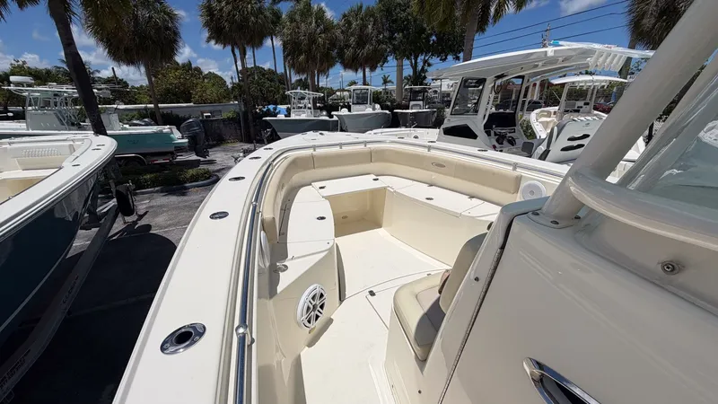 Slide: The Image of 2015 Cobia 296 Center Console boat docked at marina. - 4