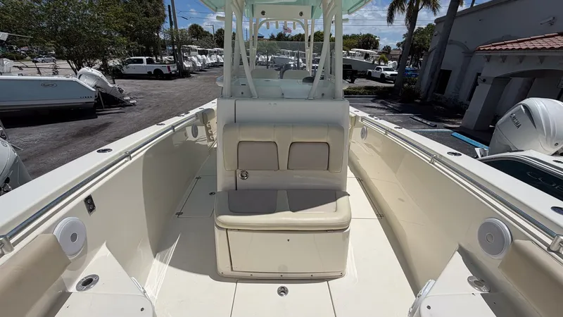 Slide: The Image of 2015 Cobia 296 Center Console boat, interior view, marina in background. - 5