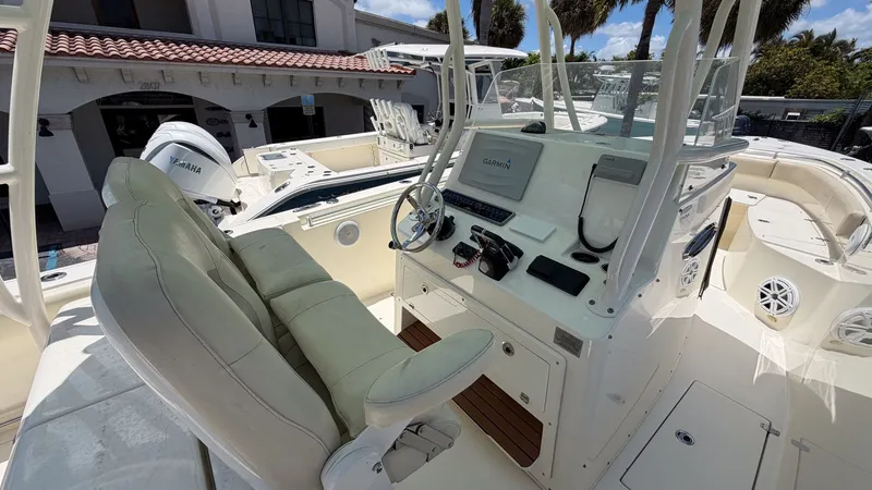 Slide: The Image of 2015 Cobia 296 Center Console boat with helm and Garmin equipment. - 7