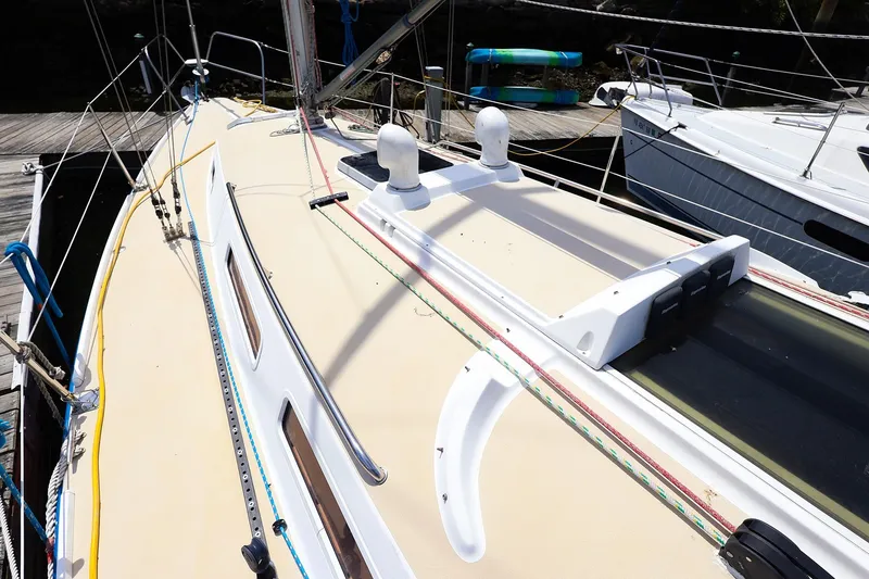 Slide: The Image of 1998 J Boats J/32 sailboat deck with rigging and hatches, docked at marina. - 13