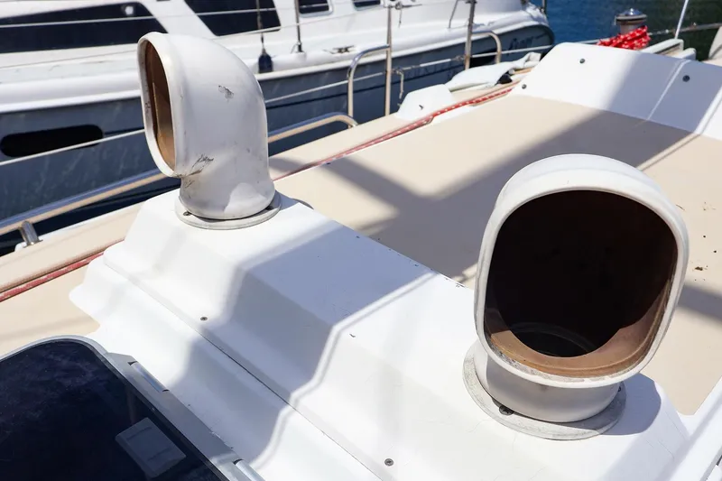 Slide: The Image of Deck vents on a 1998 J Boats J/32 sailboat, docked with other vessels. - 15