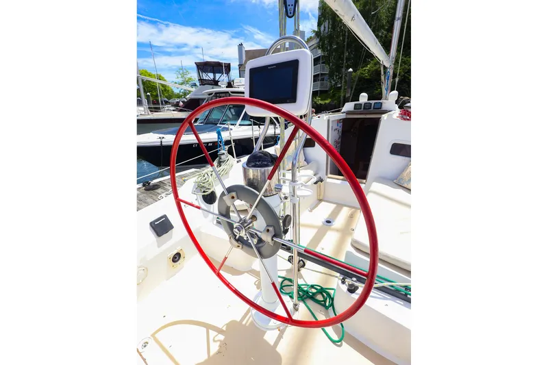 Slide: The Image of 1998 J Boats J/32 sailboat cockpit with red steering wheel and navigation equipment. - 20
