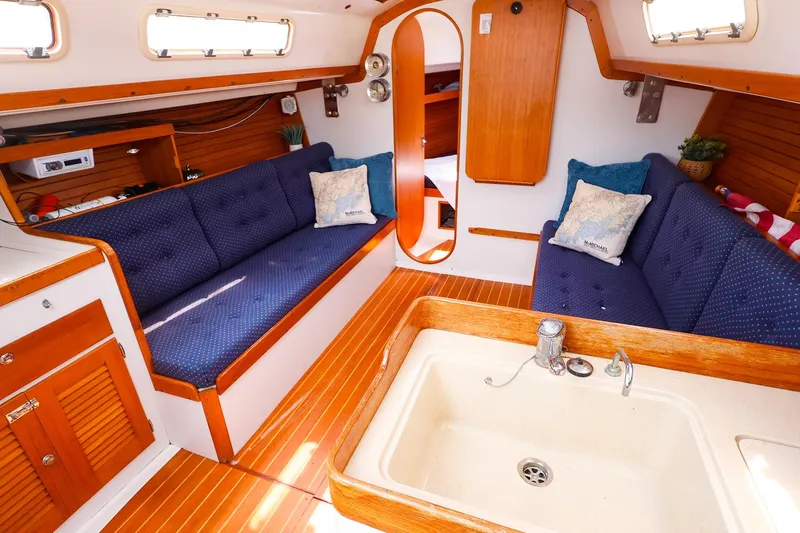 Slide: The Image of Interior of 1998 J Boats J/32 sailboat with cozy seating and wooden finishes. - 23