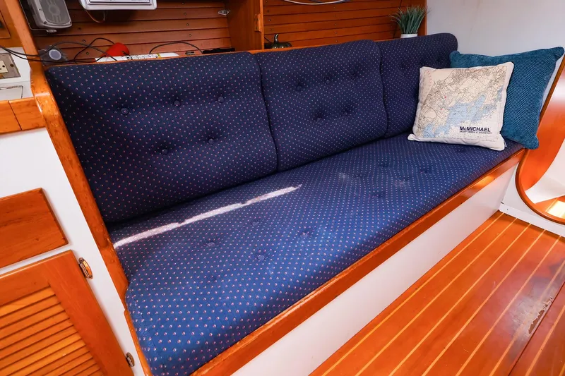 Slide: The Image of Interior of a 1998 J Boats J/32 sailboat with blue cushioned seating. - 24