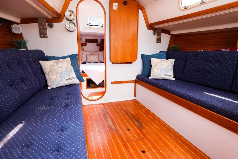 Slide: The Image of Interior of a 1998 J Boats J/32 sailboat with cozy seating and wooden flooring. - 26