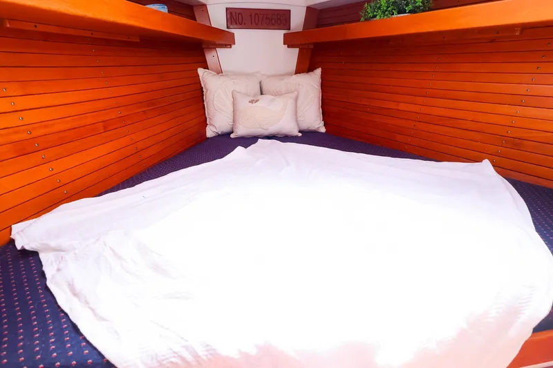 Slide: The Image of Cozy cabin interior of 1998 J Boats J/32 with wooden paneling and bedding. - 29