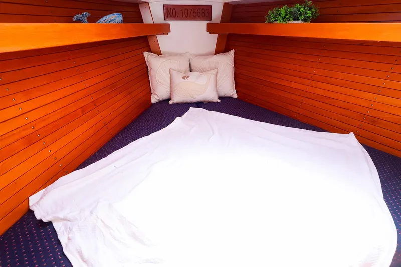 Slide: The Image of Cozy cabin interior of 1998 J Boats J/32 with wooden paneling and bedding. - 30