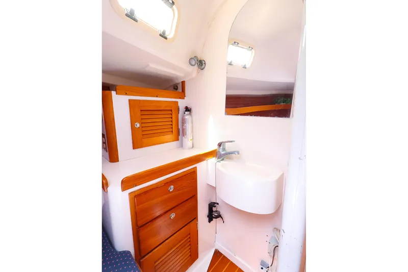Slide: The Image of 1998 J Boats J/32 yacht bathroom with wooden cabinets and compact sink. - 35