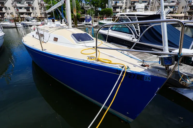 Slide: The Image of 1998 J Boats J/32 sailboat docked in a marina, featuring a sleek blue hull. - 4