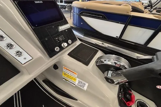 Slide: The Image of Control panel of 2026 Barletta Corsa 23UC boat with steering and display. - 23