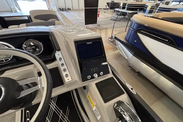 Slide: The Image of 2026 Barletta Corsa 23UC boat dashboard and controls in showroom setting. - 24