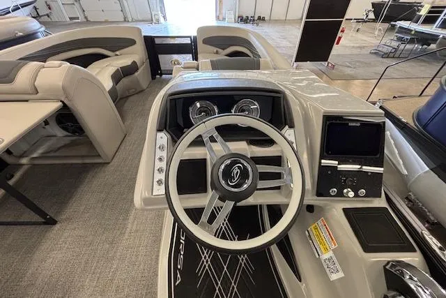 Slide: The Image of 2026 Barletta Corsa 23UC boat interior with steering wheel and dashboard controls. - 25
