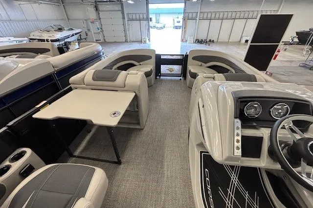 Slide: The Image of 2026 Barletta Corsa 23UC pontoon boat interior with seating and helm in a showroom. - 27