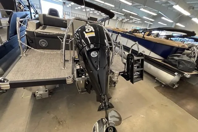Slide: The Image of 2026 Barletta Corsa 23UC pontoon boat with powerful outboard motor in showroom setting. - 3