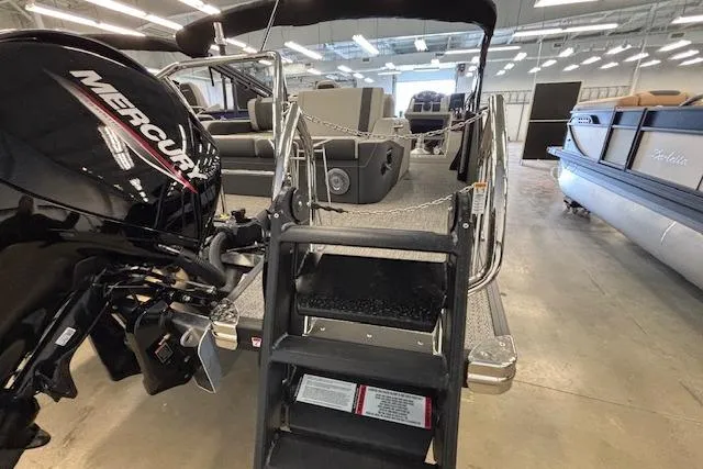 Slide: The Image of 2026 Barletta Corsa 23UC pontoon boat with Mercury engine in showroom. - 5