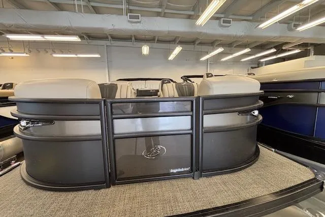Slide: The Image of 2026 Barletta Corsa 23UC pontoon boat in showroom, featuring sleek design and comfortable seating. - 8