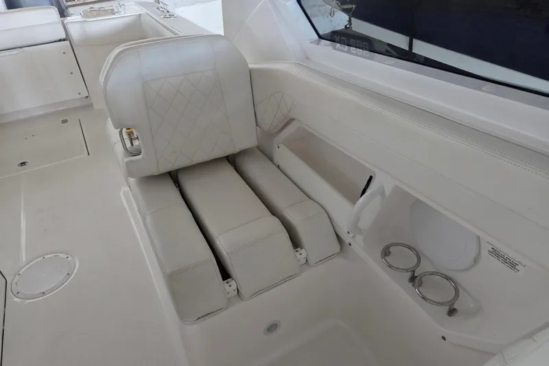 Slide: The Image of 2019 Edgewater 262CX Crossover boat interior with white seating and cup holders. - 15