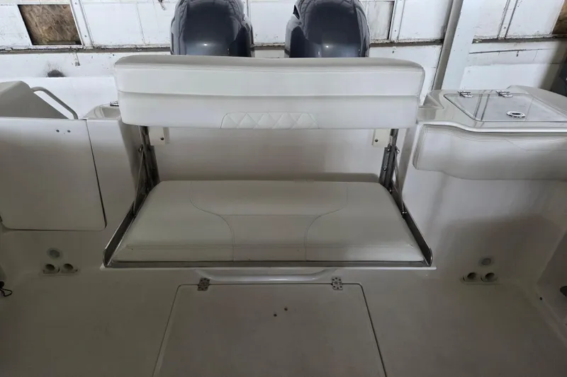 Slide: The Image of 2019 Edgewater 262CX Crossover boat interior with foldable seating and dual engines. - 17